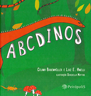 ABCDinos é um dos livros didáticos indicados pela biblioteca do Portal TRILHAS; a capa tem fundo verde que remete a vegetação de uma floresta e em destaque um dinossauro laranja e de pescoço bem comprido.