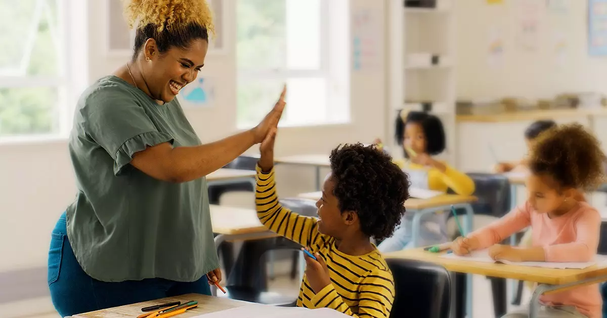 Na imagem, vemos uma professora negra cumprimentando com as mãos um estudante negro, os dois estão sorrindo